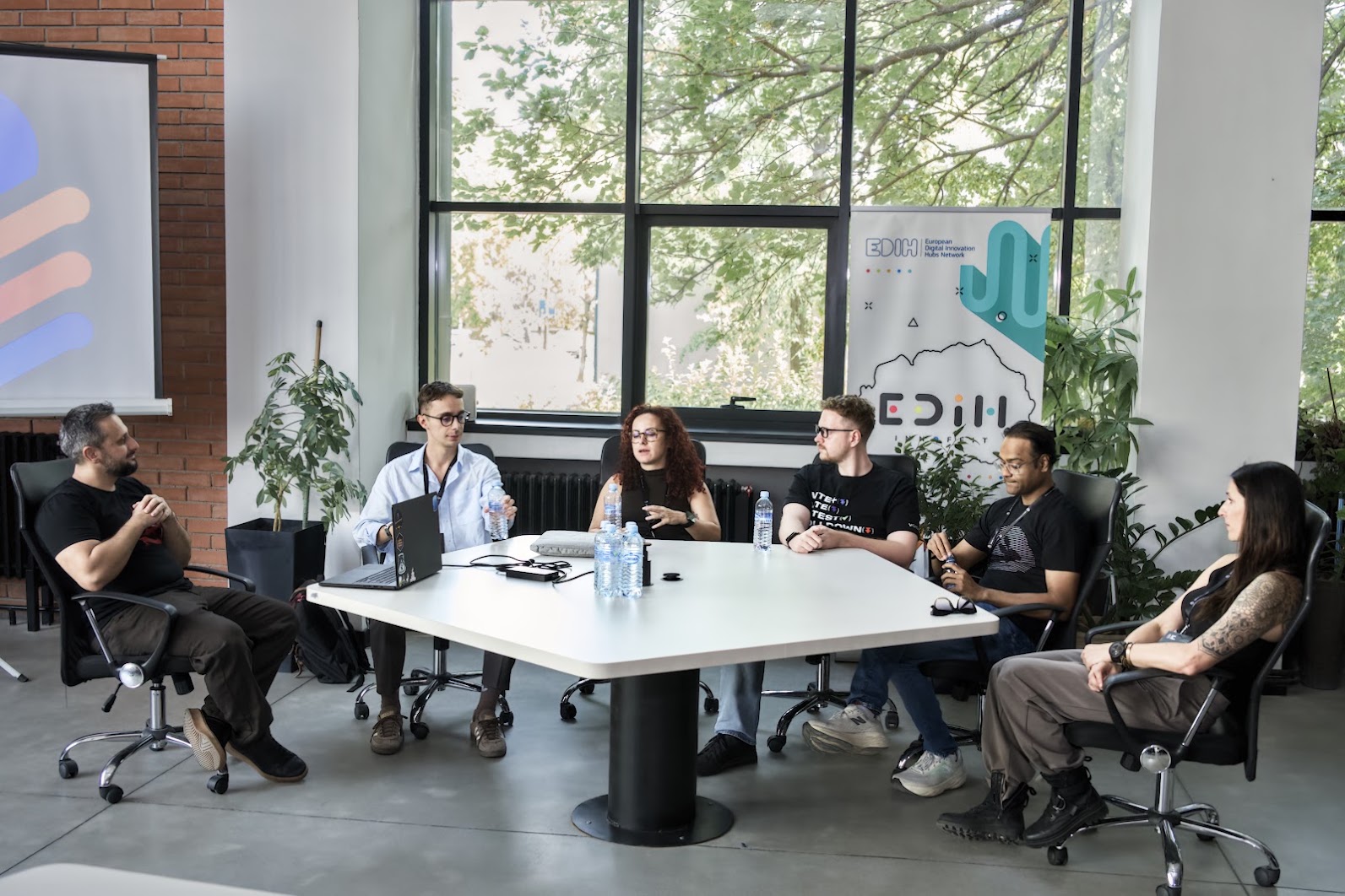 Darko Bozhinovski and five panelists in discussion around a table at Stage 5